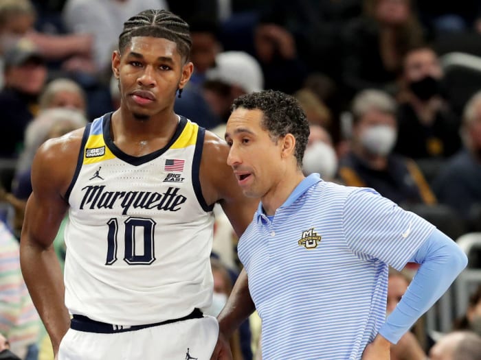 Marquette coach Shaka Smart (right) chats with Justin Lewis